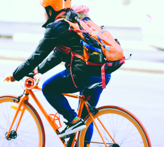 Person riding an orange bicycle