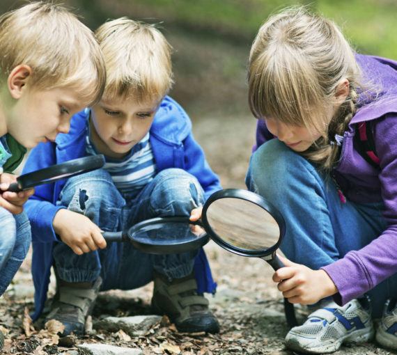 Connecting-youth-nature-children-microscopes-outside Connecting youth with nature - three children outside with magnifying glasses