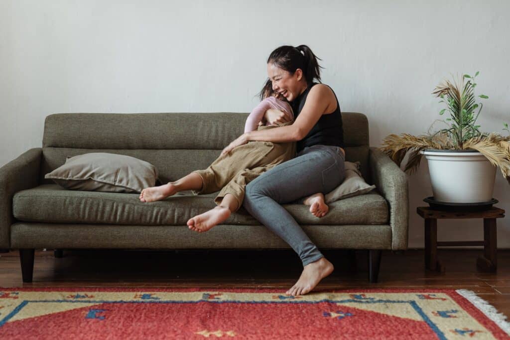 Woman hugging child on couch