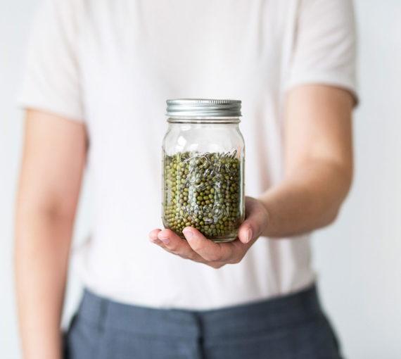 Person holding reusable mason jar