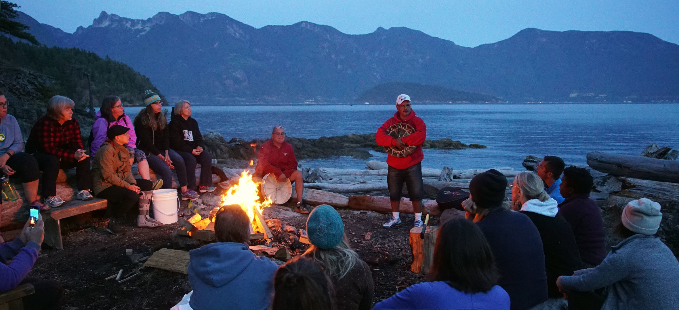 Camp Suzuki participants gather by campfire at night