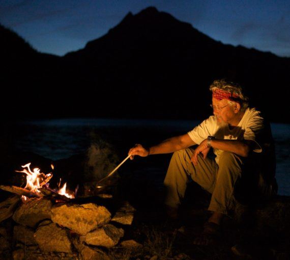 david suzuki sitting in front of fire