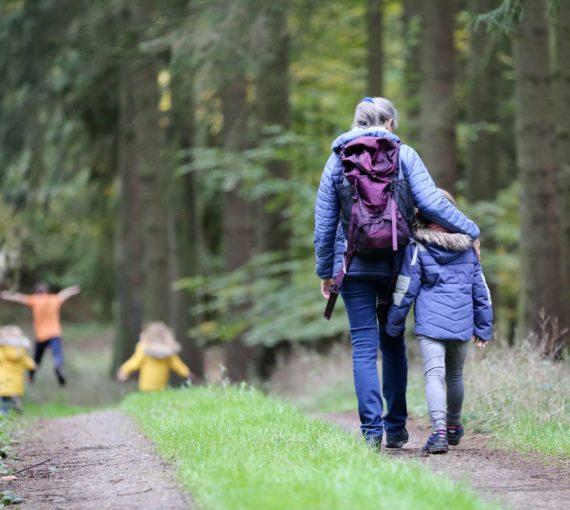 woman-and-family-walking-in-forest Woman and family walking in a forest