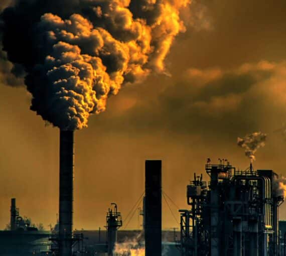 A polluted sky with smoke stacks and clouds