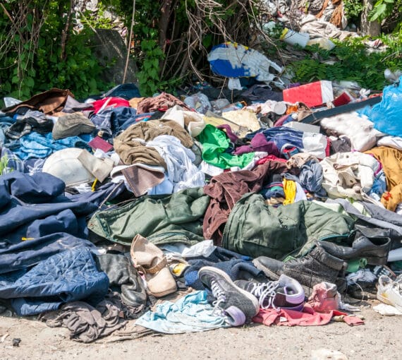 A pile of clothing and waste left discarded.